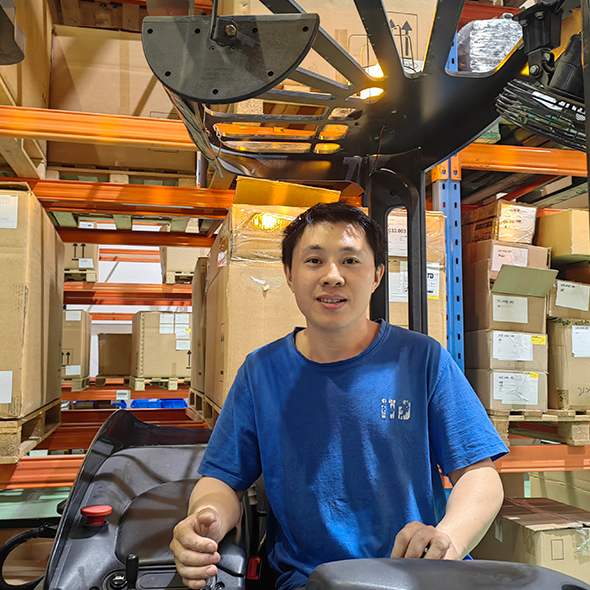 A man in a blue iTD shirt sitting on a forklift